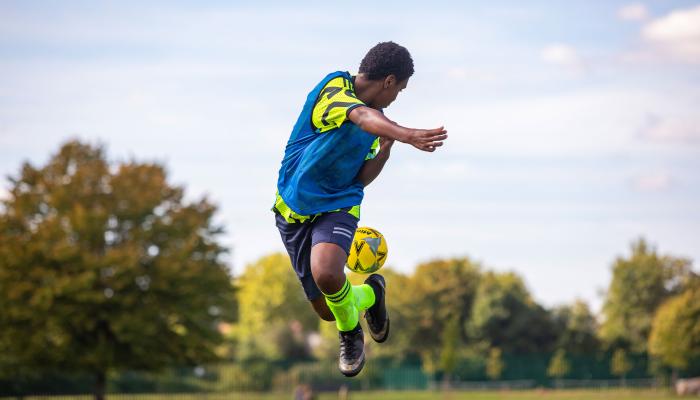 Secondary student playing football