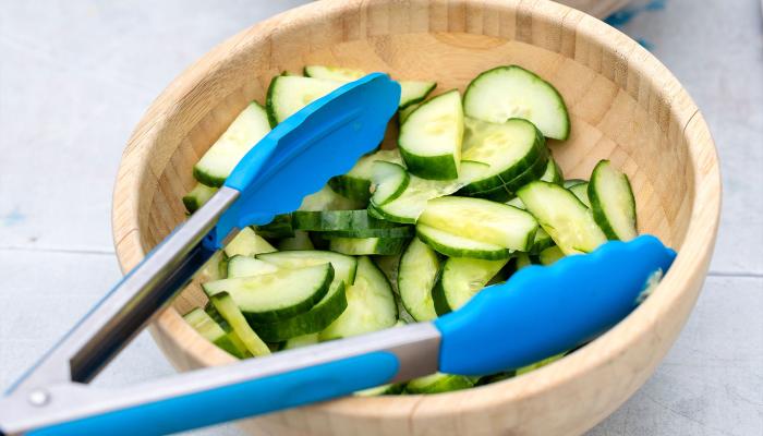Wooden bowl with chopped cucumber