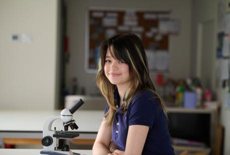 Sixth Form students at desk with microscope