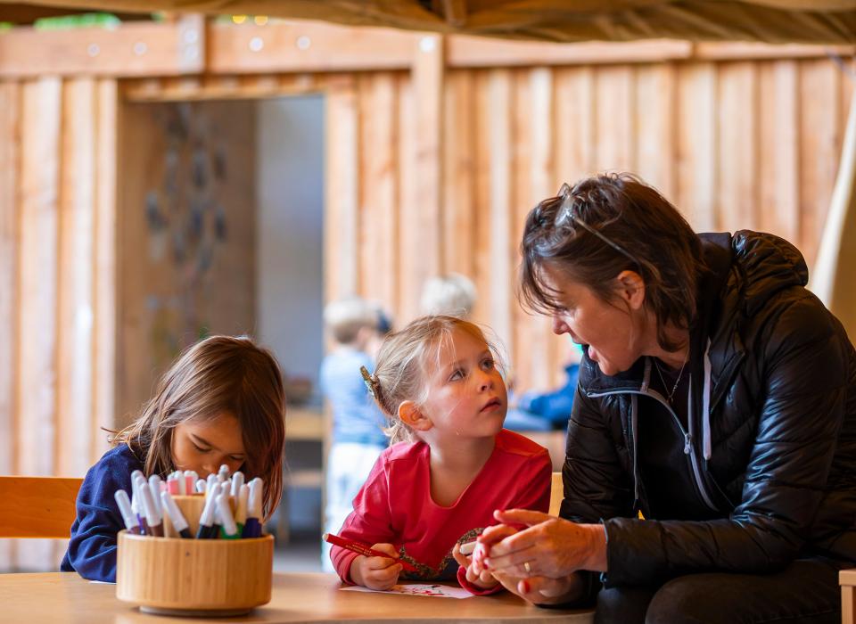 Nursery learners with teacher in outdoor classroom