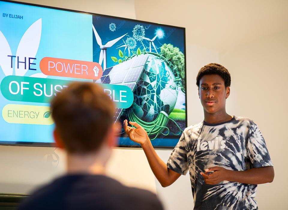 Liberty Secondary student presenting at digital screen