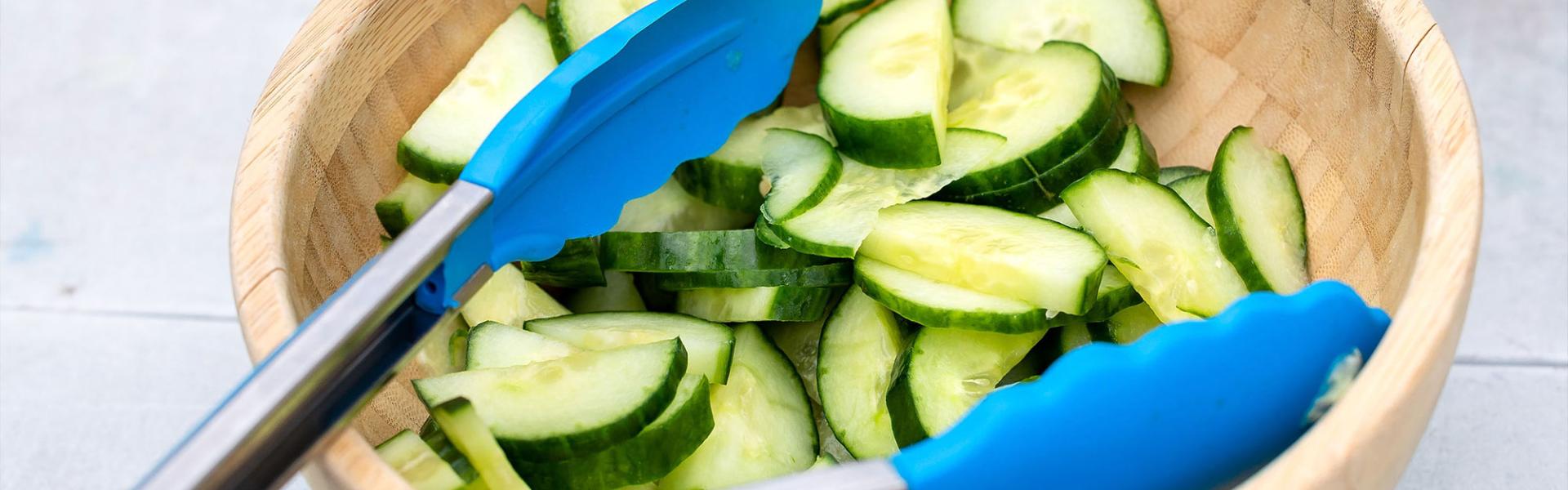 Wooden bowl with chopped cucumber